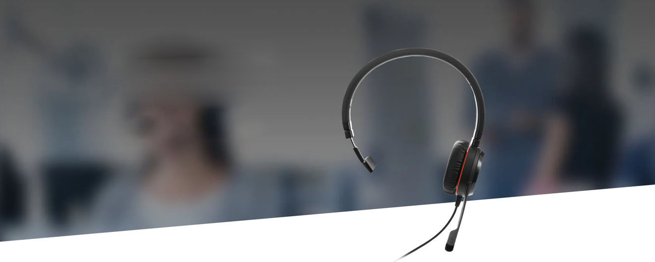 Jabra Evolve 30 II Mono Headset is dispaly against a background of a woman is using Jabra headset in an office setting.